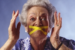 elderly woman with mouth taped shut